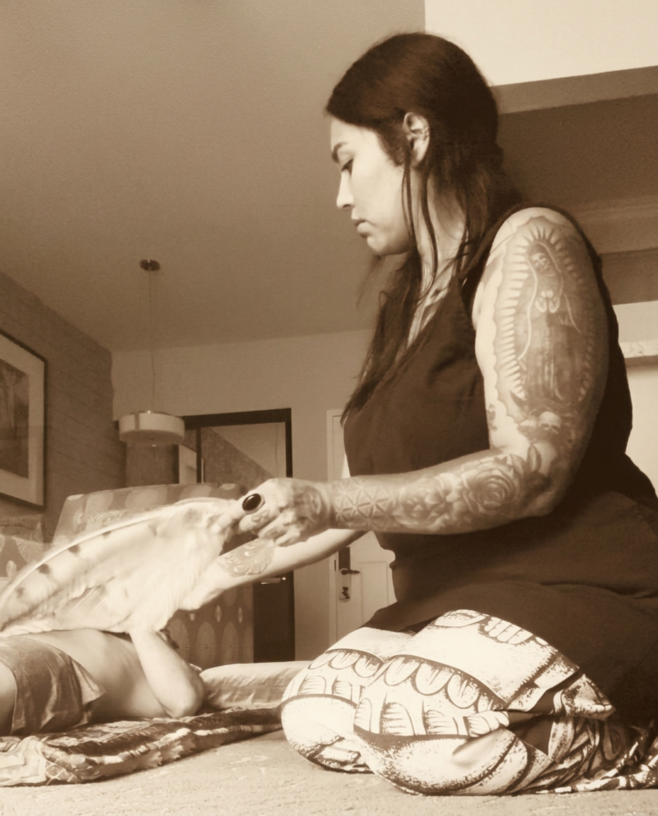 Traditional limpia — Ryanne sweeping the body with a feather in ceremony