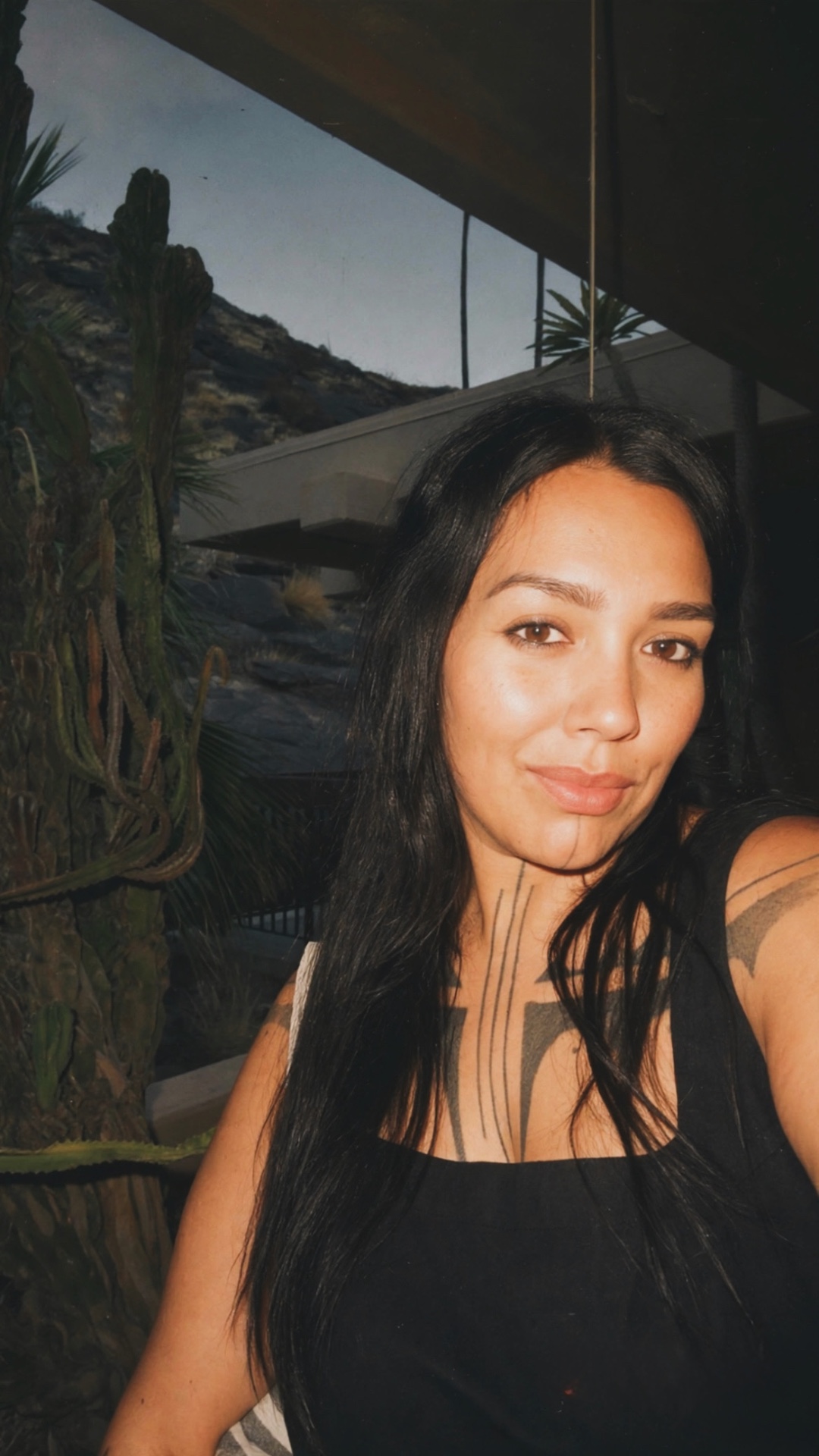 Ryanne, founder of Desert Medicine, in the desert at dusk