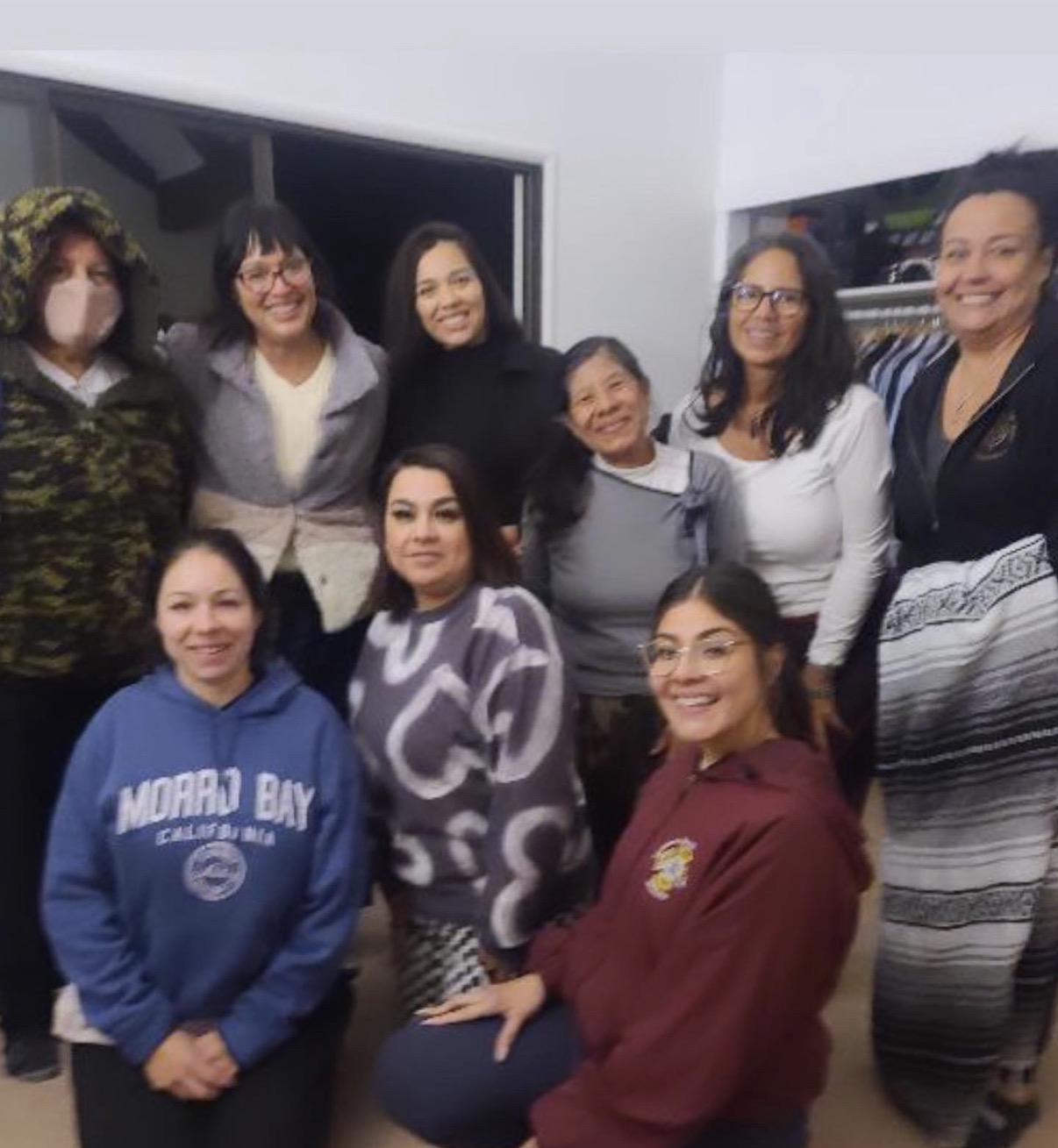 Group portrait of women gathered together after a womb healing day retreat collaboration