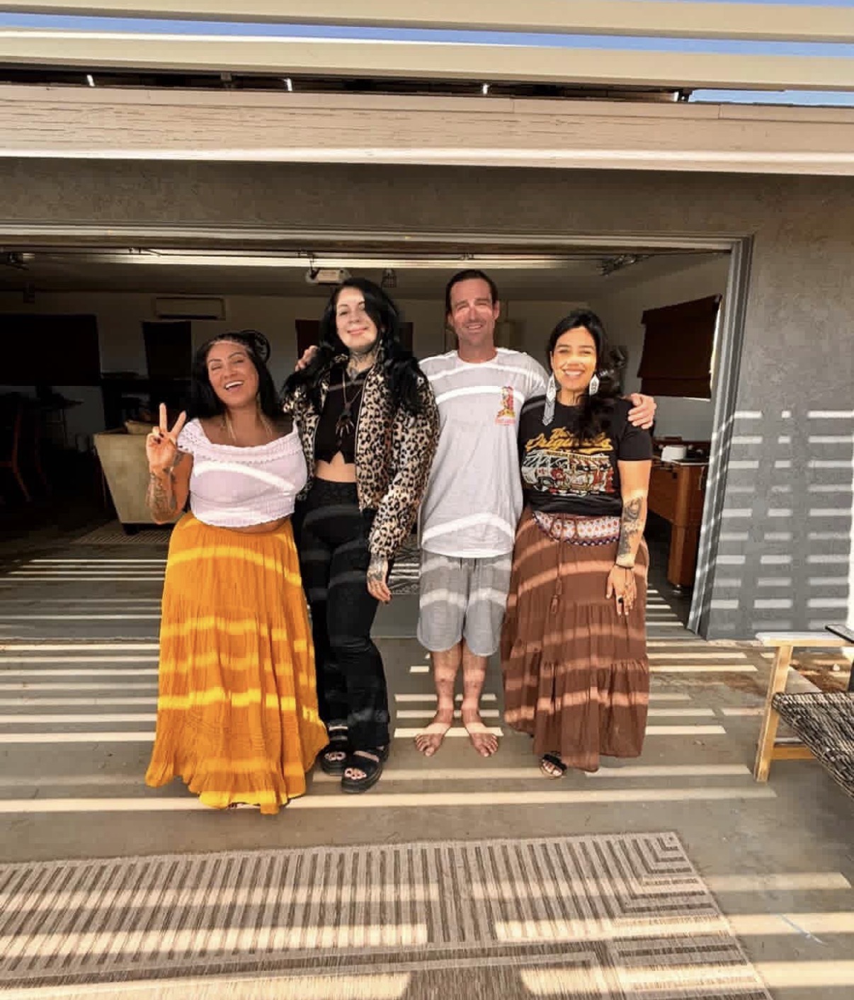 Four friends laughing together in the desert sun